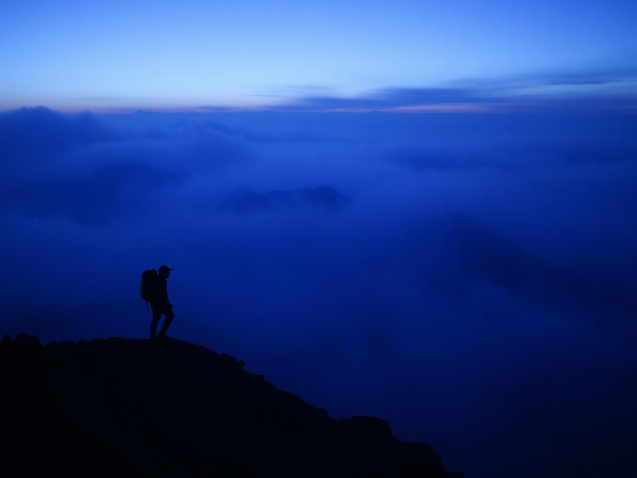 Hiking a mountain ridge at blue hour